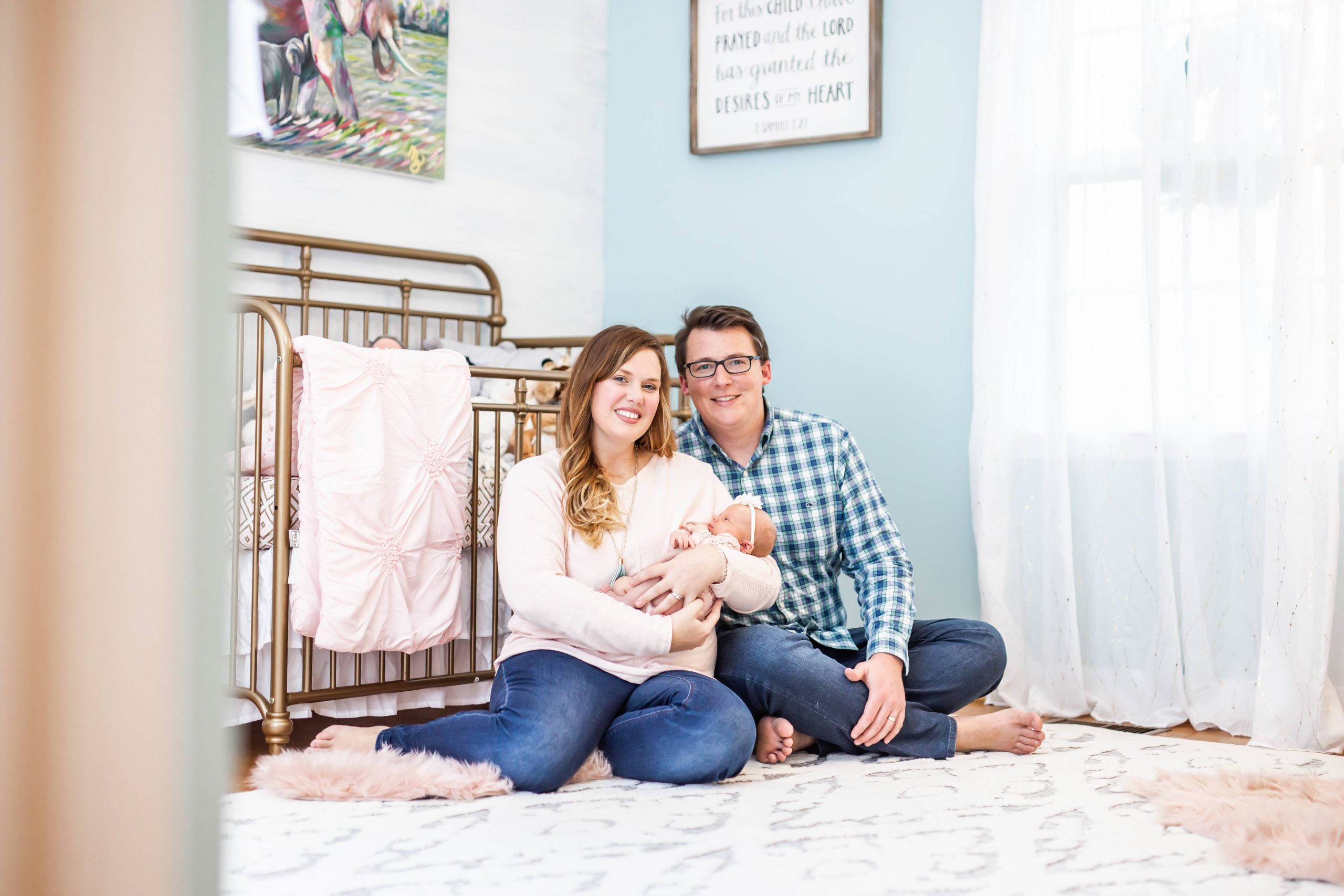 woman and husband in nursery with baby